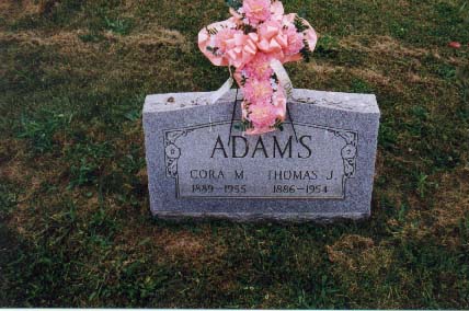 Headstone reading Adams, Cora M. 1889-1955, Thomas J. 1886-1954