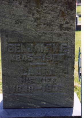 Weathered headstone reading Benjamin 1846-?, Laura his wife 1849-1905