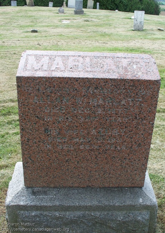Red granite block reading Marlatt, in loving memory of Allan W. Marlatt died Dec 3 1877, his wife Azuby died May 5 1911