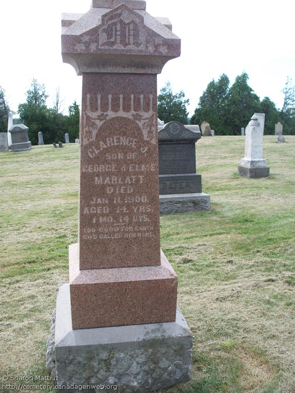 Another face of the red granite pillar reading Clarence J. son of George and Elme Marlatt died Jan 11 1900 aged 14 years 1 month 14 days