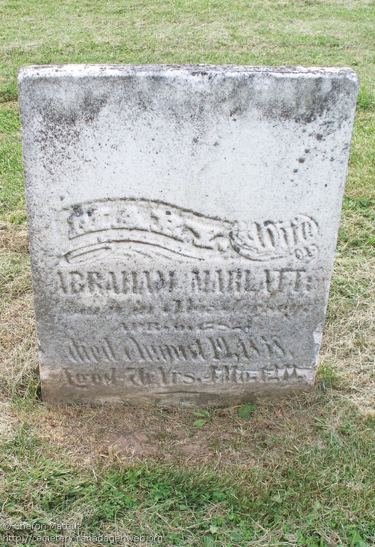 Worn white marble headstone reading Mary, wife of Abraham Marlatt, died August 19, 1858