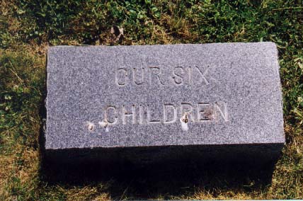 Small granite marker reading Our Six Children