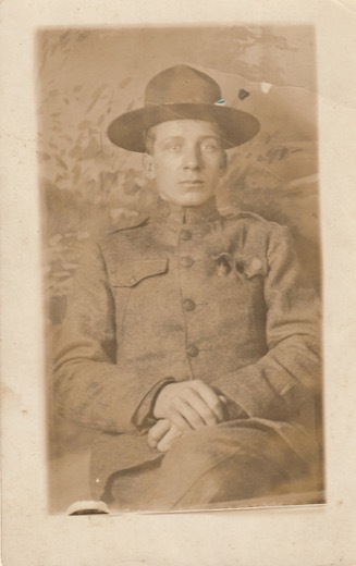 Studio portrait of George D. Malott as a young soldier, seated, in a World War I U.S. Army uniform and campaign hat